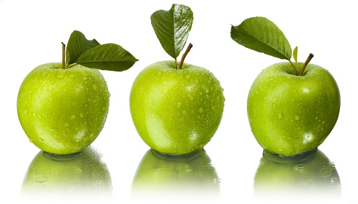 Three green apples with water droplets