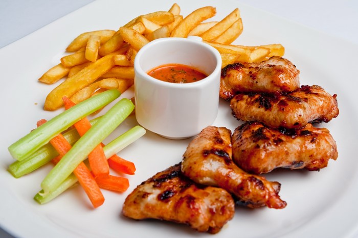 Chicken wings with french fries and dipping sauce