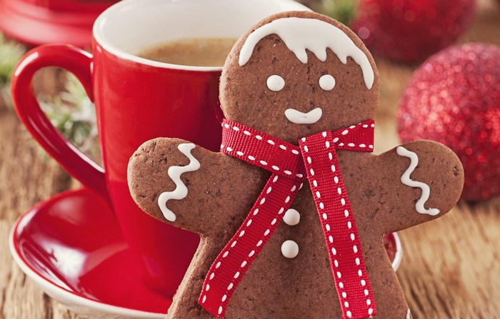 Gingerbread man cookie with coffee and Christmas decorations