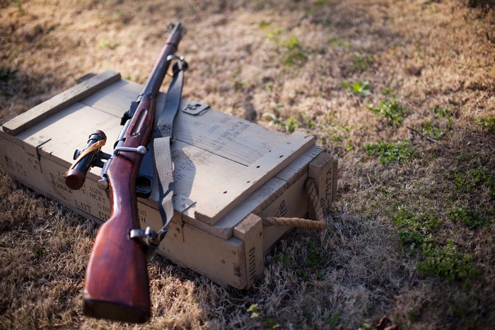Mosin-Nagant M91/30 sniper rifle on a wooden crate