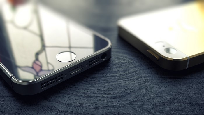 Two iPhones on a dark wooden surface