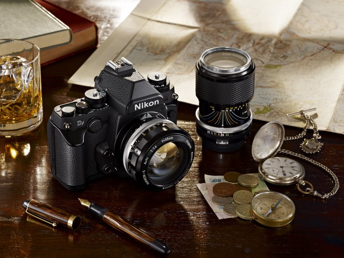 Nikon Df camera with Nikkor lens, pocket watch, and compass