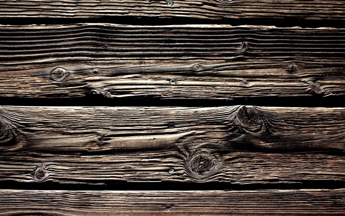Close-up of weathered wooden planks with visible grain and knots