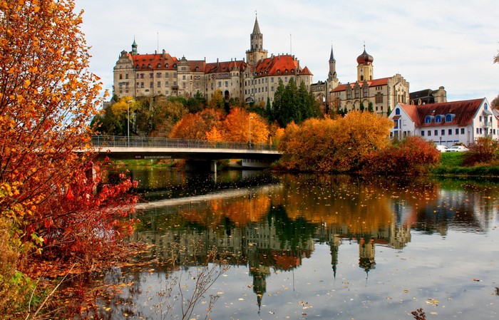 Sigmaringen Castle reflected in the Danube River during autumn