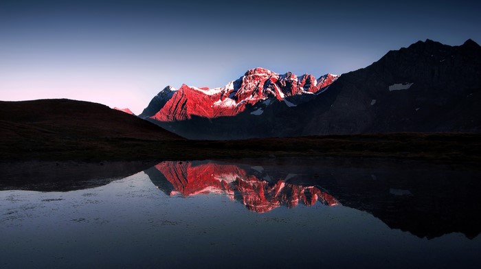 Mountains reflected in a lake at sunrise