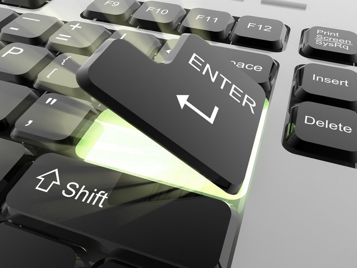 Close-up of a glowing Enter key on a keyboard