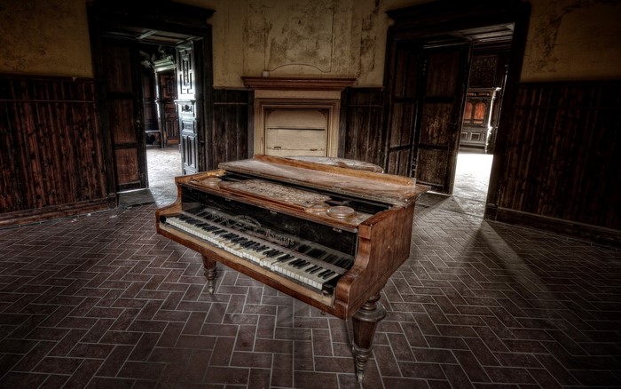 Old piano in abandoned room