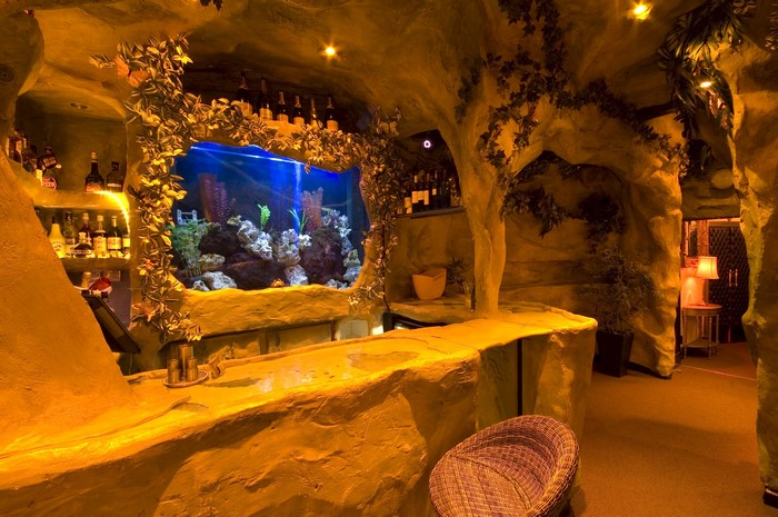 Cave-themed bar with aquarium and bottles