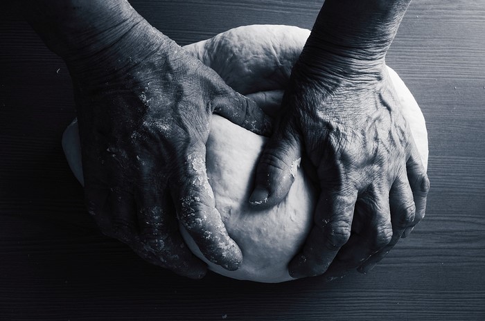 Hands kneading dough