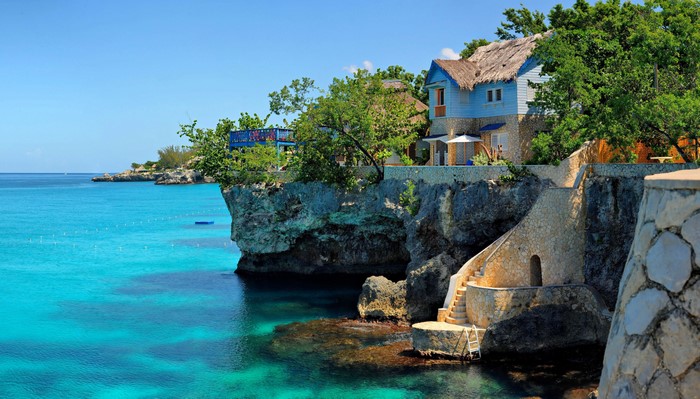 Cliffside houses overlooking turquoise water in Negril, Jamaica
