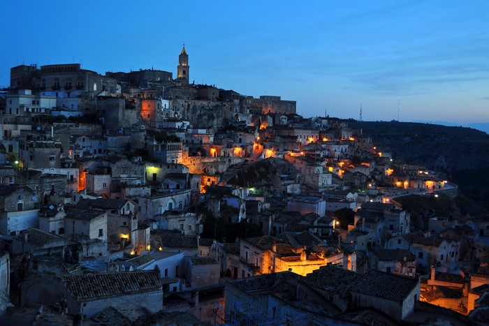 Matera, Italy at dusk with illuminated houses