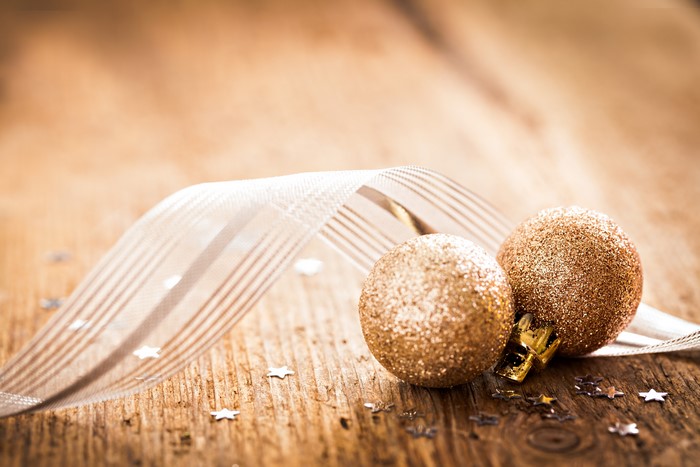 Christmas balls and ribbon on wooden background