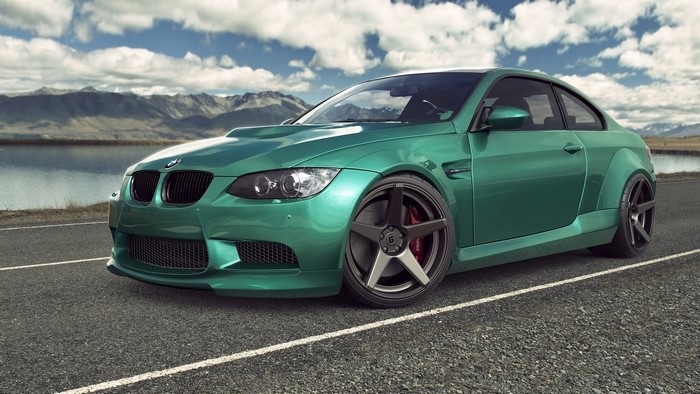 Green BMW M3 E92 parked by a lake