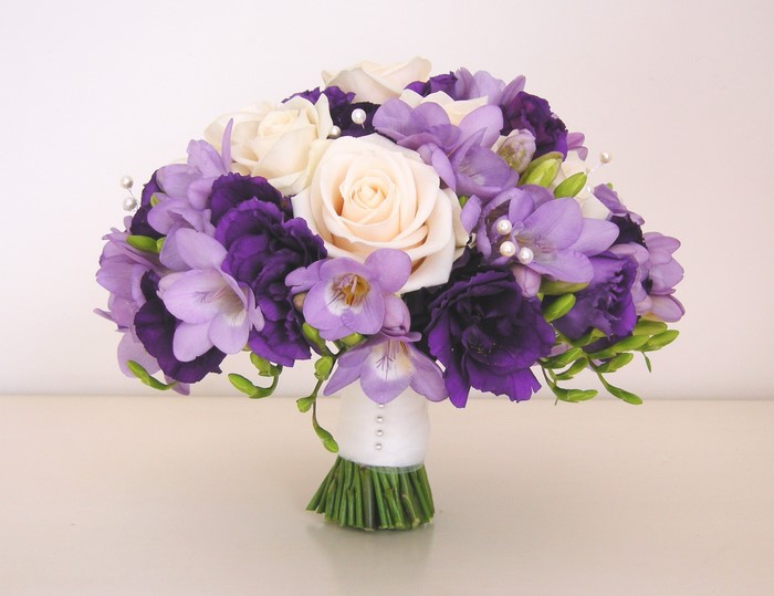 Purple and white bridal bouquet with roses and freesia