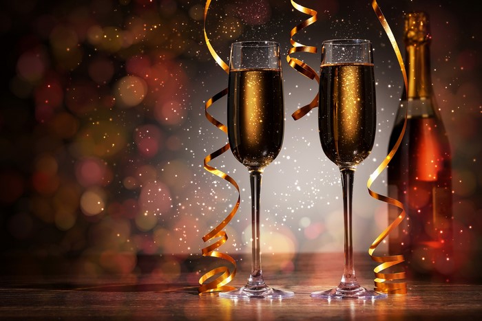 Champagne glasses and bottle with ribbons and bokeh