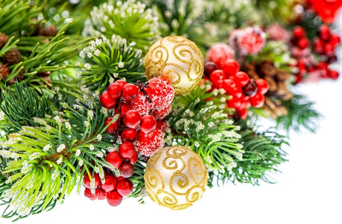 Christmas tree branches with ornaments and berries