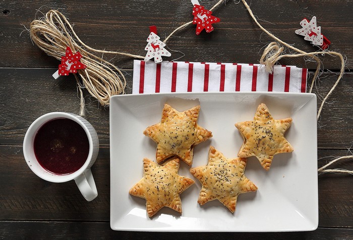 Star pastries and cup of drink on wooden table