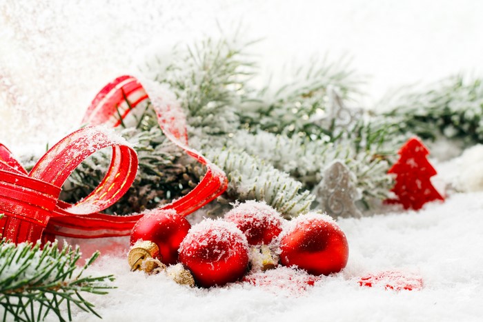 Christmas ornaments and ribbon on snow
