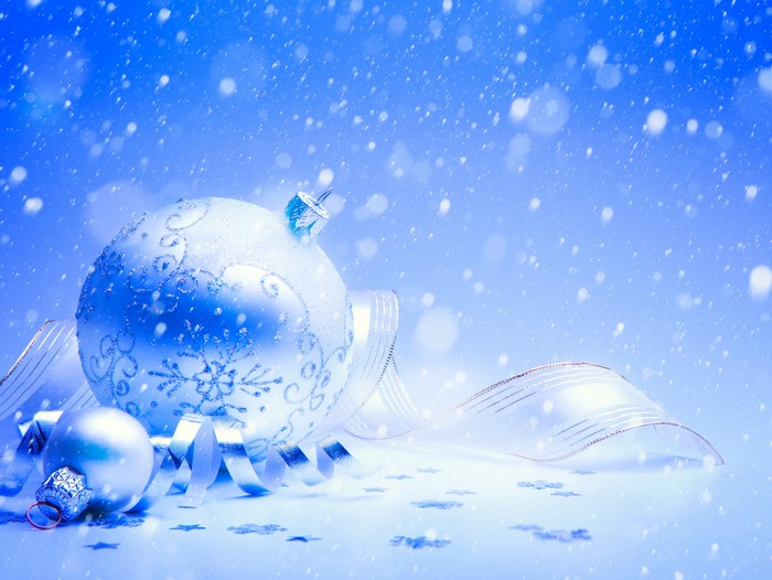 Christmas ornaments and ribbon with falling snow