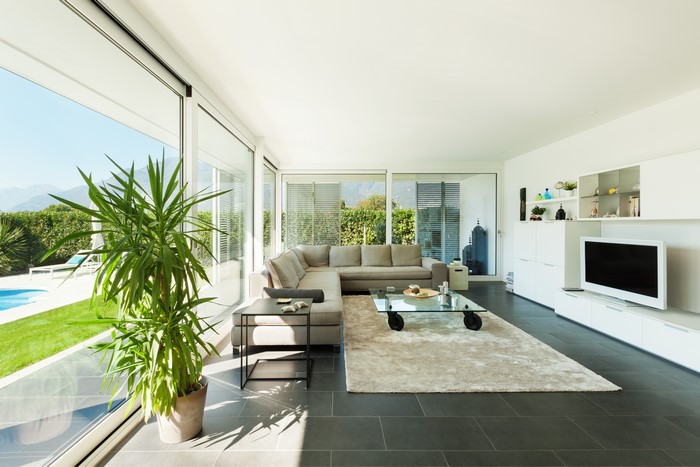 Modern living room with sectional sofa and large windows