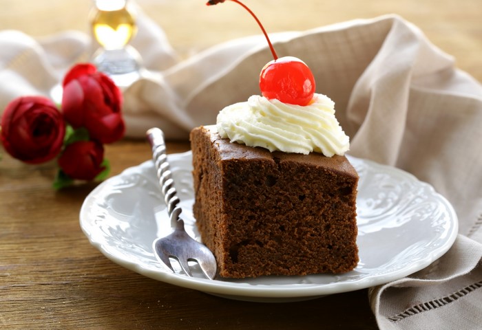 Chocolate cake with whipped cream and cherry