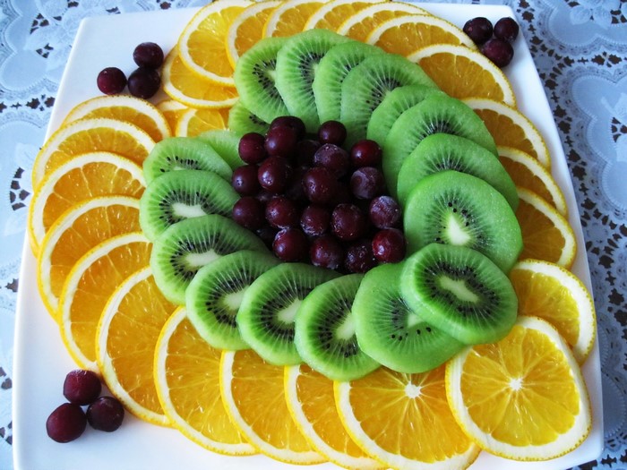 Fruit platter with oranges, kiwis, and cherries