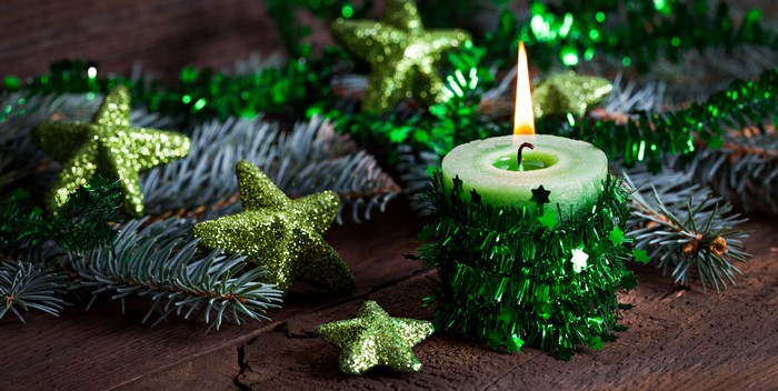 Green candle with Christmas decorations