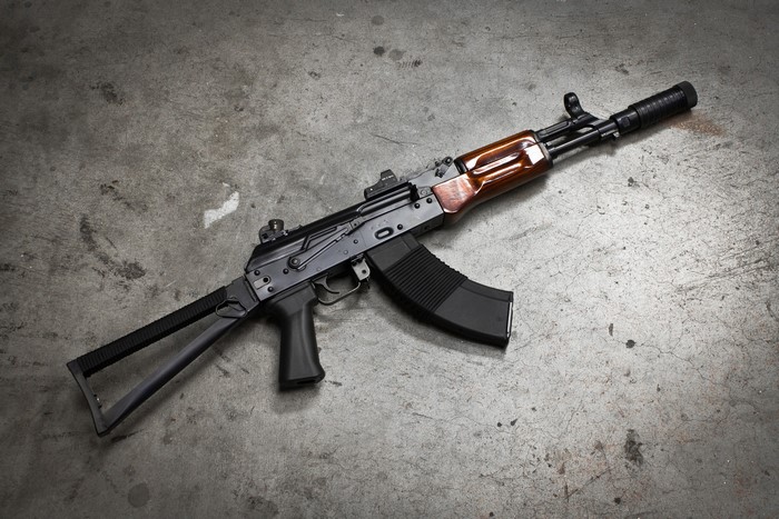 AK-74 assault rifle with wooden furniture and suppressor