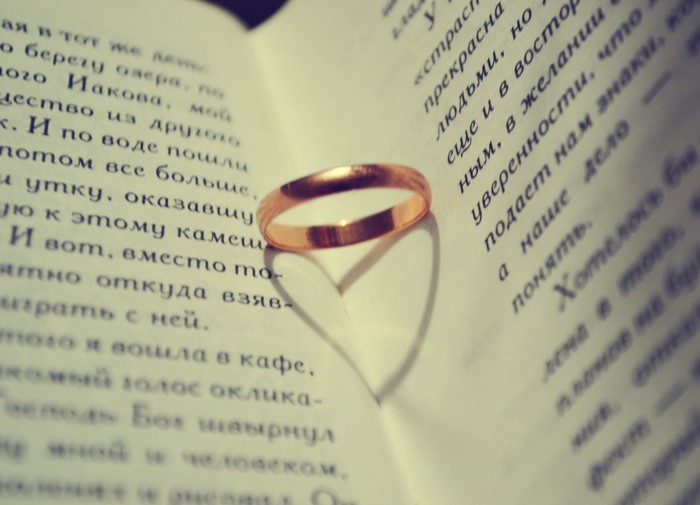 Ring casting a heart shadow on an open book
