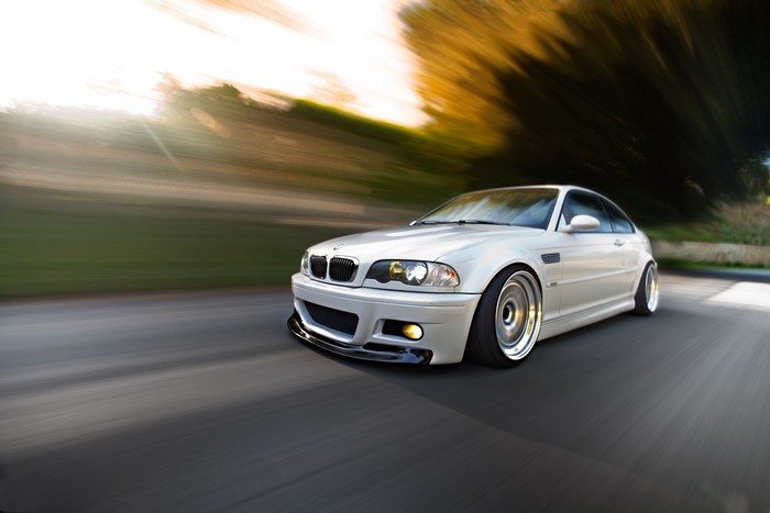 White BMW M3 E46 driving on a road