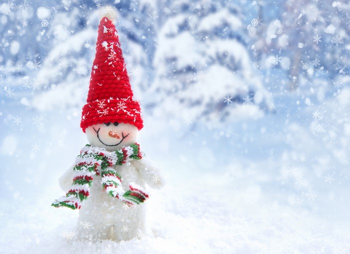 Snowman with red hat and scarf in winter