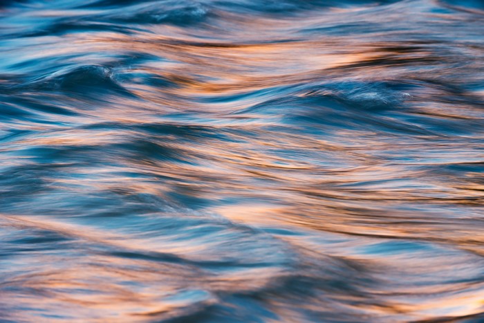 Abstract close-up of flowing water with reflections