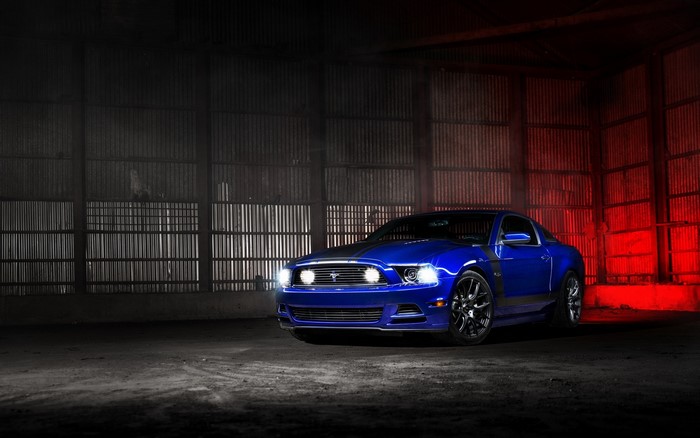 Blue Ford Mustang in a warehouse