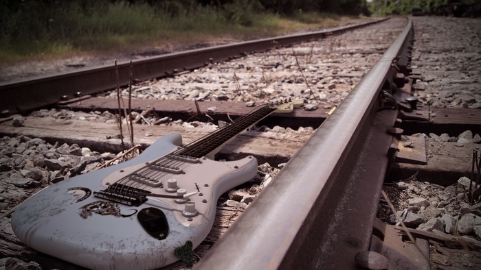 Electric guitar on railroad tracks