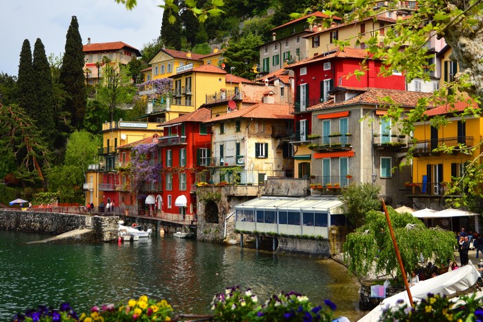 Colorful houses on a hillside by a lake in Varenna, Italy