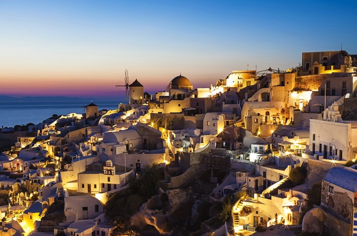 Santorini, Greece at twilight with windmills and sea