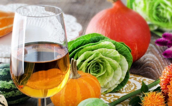 Wine glass with pumpkins and decorative cabbage