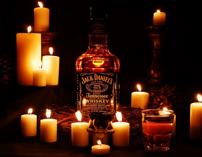 Jack Daniel's Tennessee Whiskey bottle with candles