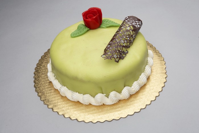 Green frosted cake with red rose decoration