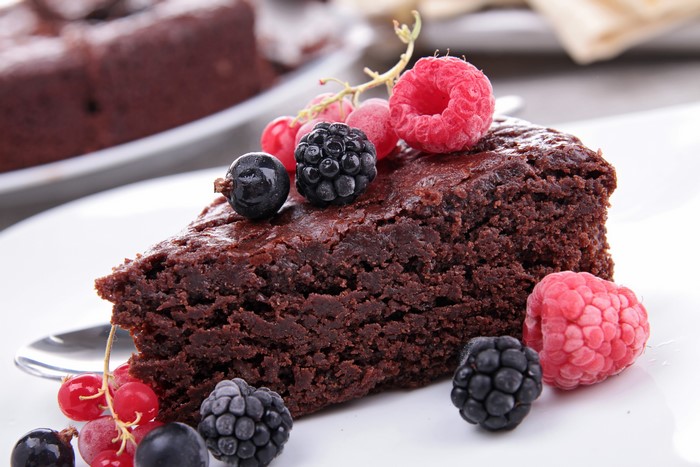 Slice of chocolate cake with berries