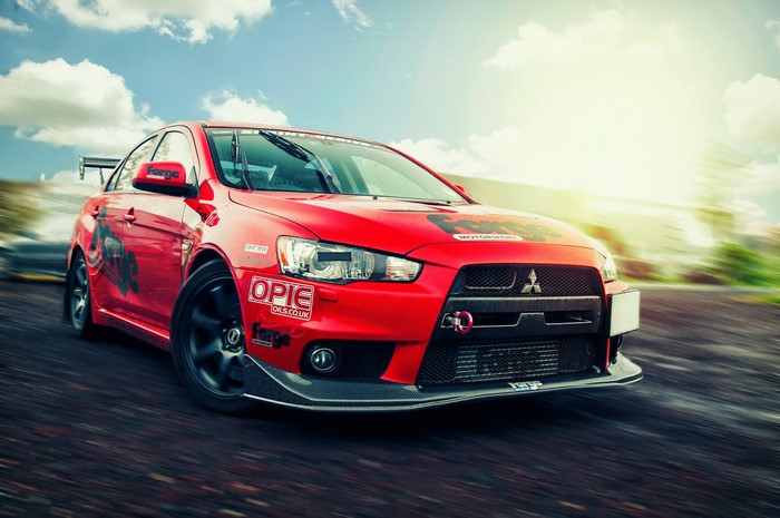Red Mitsubishi Lancer Evolution X with racing decals