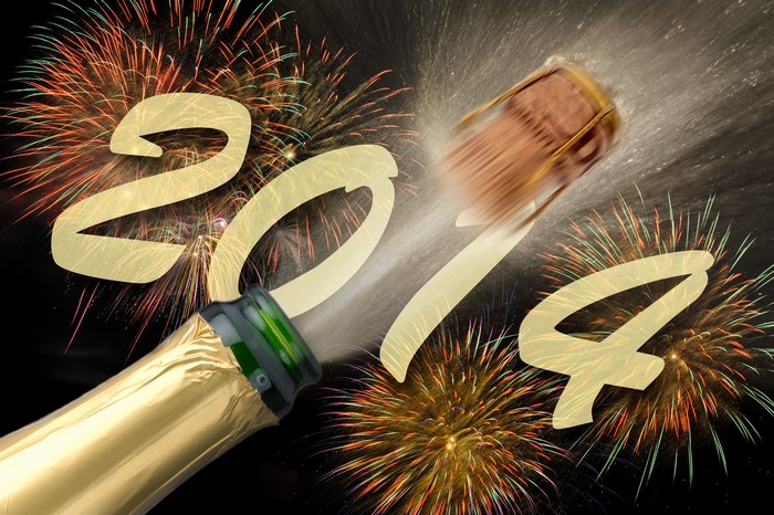 Champagne popping with fireworks and the year 2014