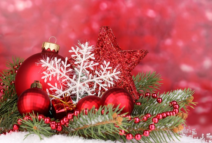 Christmas ornaments with pine branches and red background