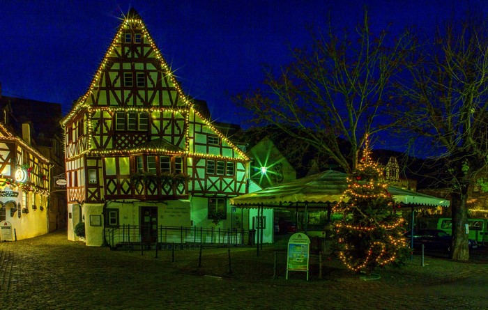 Half-timbered houses decorated with Christmas lights at night in Germany