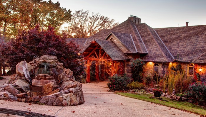 Stone house with waterfall and autumn trees in Arkansas
