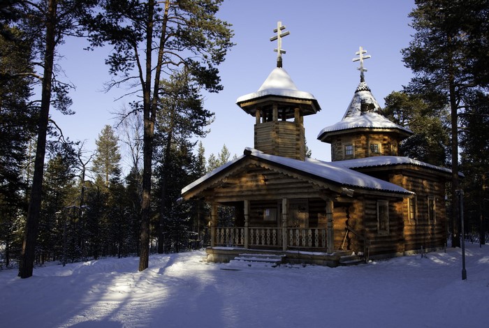 Wooden Orthodox Church in Snowy Forest, Lapland, Finland