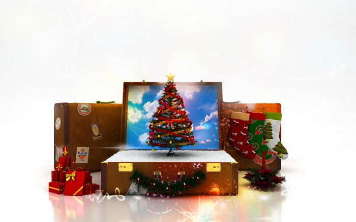 Christmas travel with decorated suitcases and gifts