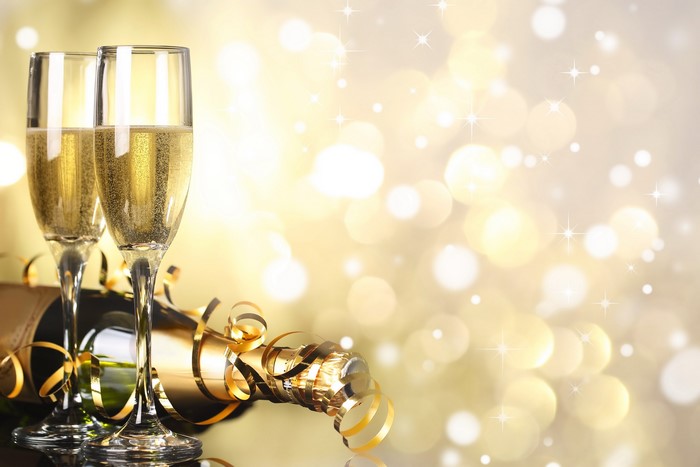 Champagne glasses and bottle with golden ribbons