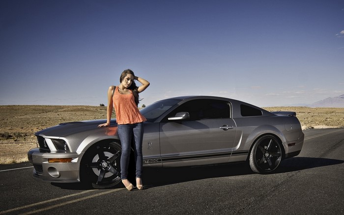 Woman posing with a Ford Mustang Shelby GT500
