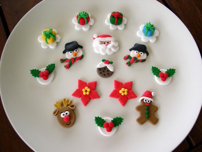 Christmas themed fondant decorations on a white plate